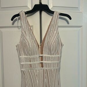 Brand new never worn. Showy in front. Bottom slit. Cream, white sequins dress.